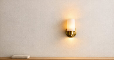 Layered lighting is a cornerstone of contemporary interior design, supporting both function and atmosphere in modern living and mixed-use spaces. Wall-mounted fixtures play a distinct role in enhancing light quality, adding depth, and providing flexibility where ceiling and portable lights fall short. Making the right choices for these fixtures can refine circulation, highlight materials, and define zones within open layouts. Today’s designers and homeowners are seeking balanced schemes that integrate multiple sources of illumination for visual comfort and versatility. Visual Comfort, a brand that designs and curates decorative and architectural lighting for residential and commercial environments, exemplifies this approach. When constructing a lighting plan, attention to decorative wall lights, especially in spaces with varied heights and uses, ensures a cohesive result. Strategic selection and placement of wall-mounted fixtures allow lighting to become a deliberate architectural layer, contributing both to task performance and visual interest. Choosing fixtures that suit the spatial layout and functional intent can significantly enhance ambience, user comfort, and aesthetic outcome. How layered lighting enhances contemporary interiors Effective layered lighting starts with understanding the three fundamental layers: ambient, task, and accent illumination. Ambient light provides the overall brightness needed for safe movement and general use, often supplied by ceiling sources. Wall-mounted fixtures can reinforce this layer in areas where ceiling lights might create shadows or leave gaps. Task lighting focuses illumination on work surfaces, reading nooks, or specific activity zones. Wall-mounted sources, such as sconces or directional lights, can supplement overhead fixtures to reduce eye strain and support precision. Accent lighting highlights architectural features, artwork, or textured wall surfaces, and can be achieved with strategically placed wall fixtures. Balancing these layers demands thoughtful consideration. Excess brightness, especially from a single direction, can cause discomfort or flatten spatial dimensions. Linking wall-mounted lighting to spatial requirements and user needs creates an adaptable environment without harsh glare or contrast. Specific functions wall-mounted fixtures can support Wall-mounted fixtures can be used in circulation zones, such as corridors, stairwells, and entries, where they offer guidance without cluttering walkways. Properly spaced, they can support wayfinding and safety, distinguishing boundaries and thresholds in spaces that benefit from subtle direction cues. These fixtures are useful beside beds, sofas, and work surfaces where targeted light is needed but floor space is limited. Wall lights free up surfaces for daily use and, with adjustable arms or shades, can support flexibility as routines and arrangements change throughout the day. Wall-mounted fixtures can also add depth through illumination of texture, millwork, or repeating architectural elements. Fixtures can graze stone, wood, or decorative panelling, highlighting rhythm and materiality that might otherwise remain unnoticed. Consistent placement along walls brings order and definition, especially in open-plan layouts where subtle cues establish functional sub-areas. Careful fixture orientation and choice of shielding help avoid glare and harsh spots, while directional light can emphasise verticality or anchor a seating arrangement. Layering these effects with other sources can help keep the environment dynamic yet coherent. Guidelines for positioning and scale within the space Mounting height and proportion are central to the effectiveness of wall-mounted lighting. Fixtures are often installed with the light source around eye level to support comfortable visibility without direct exposure. Location can vary depending on ceiling height, intended use, and the fixture’s optical design. The scale of the fixture should relate to the surface area of the wall and the ceiling height. Larger spaces can accommodate more substantial fittings, while compact settings benefit from discreet, lower-profile options. Even in tight corridors, proper sizing prevents overcrowding and helps maintain visual balance. When spacing wall-mounted fixtures, aim for consistent intervals to ensure even illumination, especially along extended corridors. Deliberate deviations, using pairs or clusters, can mark transitions or accentuate special features without introducing confusion. Decorative wall lights are often suitable for flexible environments where lighting needs evolve. Fixture orientation and the presence of shields or diffusers play a key role in mitigating glare. Upward or downward-facing shades, frosted glass, or baffles help soften light transitions and protect sightlines, a common consideration in residential zones where relaxation and comfort are priorities. Integrating fixtures with architectural and stylistic language A successful interior uses wall-mounted fixtures that harmonise with the overall design language, whether minimal, traditional, or transitional. Selecting forms that echo architectural lines or repeat motifs found in millwork, trim, or cabinetry helps reinforce unity between lighting and structure. Finishes, while often matched to hardware or metalwork, should not appear over-coordinated. Slightly varied tones and textures can add depth and avoid monotony. Consider the room’s palette and adjacent materials, letting contrast or subtlety serve the intent of the space without overwhelming it. Symmetry and repetition can support formal or classically inspired interiors. Balanced arrangements of fixtures on either side of an artwork, mirror, or opening reinforce architectural order, while asymmetry may suit casual, eclectic, or contemporary environments. Repeated fixtures can help create rhythm and clarity. It is important to prioritise compatibility between fixture proportions and details found elsewhere in the space. Achieving this integration requires attention to detail during the lighting design process. Light quality and performance criteria explained Choosing light quality involves understanding colour temperature and colour rendering. Warmer colour temperatures, such as 2700K to 3000K, often suit living areas, bedrooms, and residential lounges. Cooler temperatures, such as 3500K to 4000K, are sometimes used in offices, retail, or hospitality settings. Higher colour rendering can help surface finishes, artwork, and textiles appear more accurate. In settings where material selection and presentation are important, attention to consistency in light output can affect the overall visual result. Colour appearance can also shift based on surrounding finishes and daylight conditions. Beam spread and diffusion are equally significant. Narrow beams focus attention, while wide diffusion produces general brightness with softer shadows. Optical controls like louvres or etched glass shape how shadows and highlights appear on walls and artwork. Dimming and control strategies offer flexibility for multiuse spaces. Wall dimmers or integrated sensors let users adjust intensity for entertaining, working, or resting. Compatibility with installed control systems helps ensure practical operation. Adaptability in residential and commercial environments In open-plan living arrangements, wall-mounted lighting helps define specific activity zones such as dining, relaxing, and reading without visually breaking up the space. Layering light in this way can maintain openness while supporting task-appropriate use of each area. For commercial settings, wall-mounted fixtures can support wayfinding, provide visual interest, and help establish an atmosphere aligned with the intended experience. When combined with ambient and task lighting, they can contribute to consistency across larger footprints. Spaces that change function over the day, such as multiuse rooms or hospitality lounges, can benefit from flexible wall lighting integrated with dimming or scene control. This approach can help maintain comfort across different occupancy and activity patterns. Maintenance access and durability matter in both contexts. Selecting fixtures with appropriate ingress protection, robust materials, and serviceable components can reduce disruption and help preserve lighting performance over time.