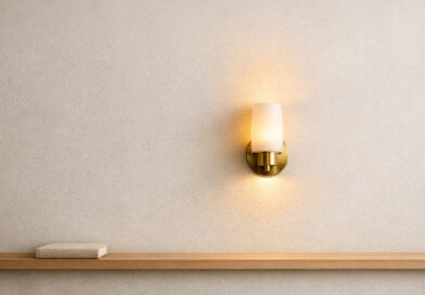 Layered lighting is a cornerstone of contemporary interior design, supporting both function and atmosphere in modern living and mixed-use spaces. Wall-mounted fixtures play a distinct role in enhancing light quality, adding depth, and providing flexibility where ceiling and portable lights fall short. Making the right choices for these fixtures can refine circulation, highlight materials, and define zones within open layouts. Today’s designers and homeowners are seeking balanced schemes that integrate multiple sources of illumination for visual comfort and versatility. Visual Comfort, a brand that designs and curates decorative and architectural lighting for residential and commercial environments, exemplifies this approach. When constructing a lighting plan, attention to decorative wall lights, especially in spaces with varied heights and uses, ensures a cohesive result. Strategic selection and placement of wall-mounted fixtures allow lighting to become a deliberate architectural layer, contributing both to task performance and visual interest. Choosing fixtures that suit the spatial layout and functional intent can significantly enhance ambience, user comfort, and aesthetic outcome. How layered lighting enhances contemporary interiors Effective layered lighting starts with understanding the three fundamental layers: ambient, task, and accent illumination. Ambient light provides the overall brightness needed for safe movement and general use, often supplied by ceiling sources. Wall-mounted fixtures can reinforce this layer in areas where ceiling lights might create shadows or leave gaps. Task lighting focuses illumination on work surfaces, reading nooks, or specific activity zones. Wall-mounted sources, such as sconces or directional lights, can supplement overhead fixtures to reduce eye strain and support precision. Accent lighting highlights architectural features, artwork, or textured wall surfaces, and can be achieved with strategically placed wall fixtures. Balancing these layers demands thoughtful consideration. Excess brightness, especially from a single direction, can cause discomfort or flatten spatial dimensions. Linking wall-mounted lighting to spatial requirements and user needs creates an adaptable environment without harsh glare or contrast. Specific functions wall-mounted fixtures can support Wall-mounted fixtures can be used in circulation zones, such as corridors, stairwells, and entries, where they offer guidance without cluttering walkways. Properly spaced, they can support wayfinding and safety, distinguishing boundaries and thresholds in spaces that benefit from subtle direction cues. These fixtures are useful beside beds, sofas, and work surfaces where targeted light is needed but floor space is limited. Wall lights free up surfaces for daily use and, with adjustable arms or shades, can support flexibility as routines and arrangements change throughout the day. Wall-mounted fixtures can also add depth through illumination of texture, millwork, or repeating architectural elements. Fixtures can graze stone, wood, or decorative panelling, highlighting rhythm and materiality that might otherwise remain unnoticed. Consistent placement along walls brings order and definition, especially in open-plan layouts where subtle cues establish functional sub-areas. Careful fixture orientation and choice of shielding help avoid glare and harsh spots, while directional light can emphasise verticality or anchor a seating arrangement. Layering these effects with other sources can help keep the environment dynamic yet coherent. Guidelines for positioning and scale within the space Mounting height and proportion are central to the effectiveness of wall-mounted lighting. Fixtures are often installed with the light source around eye level to support comfortable visibility without direct exposure. Location can vary depending on ceiling height, intended use, and the fixture’s optical design. The scale of the fixture should relate to the surface area of the wall and the ceiling height. Larger spaces can accommodate more substantial fittings, while compact settings benefit from discreet, lower-profile options. Even in tight corridors, proper sizing prevents overcrowding and helps maintain visual balance. When spacing wall-mounted fixtures, aim for consistent intervals to ensure even illumination, especially along extended corridors. Deliberate deviations, using pairs or clusters, can mark transitions or accentuate special features without introducing confusion. Decorative wall lights are often suitable for flexible environments where lighting needs evolve. Fixture orientation and the presence of shields or diffusers play a key role in mitigating glare. Upward or downward-facing shades, frosted glass, or baffles help soften light transitions and protect sightlines, a common consideration in residential zones where relaxation and comfort are priorities. Integrating fixtures with architectural and stylistic language A successful interior uses wall-mounted fixtures that harmonise with the overall design language, whether minimal, traditional, or transitional. Selecting forms that echo architectural lines or repeat motifs found in millwork, trim, or cabinetry helps reinforce unity between lighting and structure. Finishes, while often matched to hardware or metalwork, should not appear over-coordinated. Slightly varied tones and textures can add depth and avoid monotony. Consider the room’s palette and adjacent materials, letting contrast or subtlety serve the intent of the space without overwhelming it. Symmetry and repetition can support formal or classically inspired interiors. Balanced arrangements of fixtures on either side of an artwork, mirror, or opening reinforce architectural order, while asymmetry may suit casual, eclectic, or contemporary environments. Repeated fixtures can help create rhythm and clarity. It is important to prioritise compatibility between fixture proportions and details found elsewhere in the space. Achieving this integration requires attention to detail during the lighting design process. Light quality and performance criteria explained Choosing light quality involves understanding colour temperature and colour rendering. Warmer colour temperatures, such as 2700K to 3000K, often suit living areas, bedrooms, and residential lounges. Cooler temperatures, such as 3500K to 4000K, are sometimes used in offices, retail, or hospitality settings. Higher colour rendering can help surface finishes, artwork, and textiles appear more accurate. In settings where material selection and presentation are important, attention to consistency in light output can affect the overall visual result. Colour appearance can also shift based on surrounding finishes and daylight conditions. Beam spread and diffusion are equally significant. Narrow beams focus attention, while wide diffusion produces general brightness with softer shadows. Optical controls like louvres or etched glass shape how shadows and highlights appear on walls and artwork. Dimming and control strategies offer flexibility for multiuse spaces. Wall dimmers or integrated sensors let users adjust intensity for entertaining, working, or resting. Compatibility with installed control systems helps ensure practical operation. Adaptability in residential and commercial environments In open-plan living arrangements, wall-mounted lighting helps define specific activity zones such as dining, relaxing, and reading without visually breaking up the space. Layering light in this way can maintain openness while supporting task-appropriate use of each area. For commercial settings, wall-mounted fixtures can support wayfinding, provide visual interest, and help establish an atmosphere aligned with the intended experience. When combined with ambient and task lighting, they can contribute to consistency across larger footprints. Spaces that change function over the day, such as multiuse rooms or hospitality lounges, can benefit from flexible wall lighting integrated with dimming or scene control. This approach can help maintain comfort across different occupancy and activity patterns. Maintenance access and durability matter in both contexts. Selecting fixtures with appropriate ingress protection, robust materials, and serviceable components can reduce disruption and help preserve lighting performance over time.